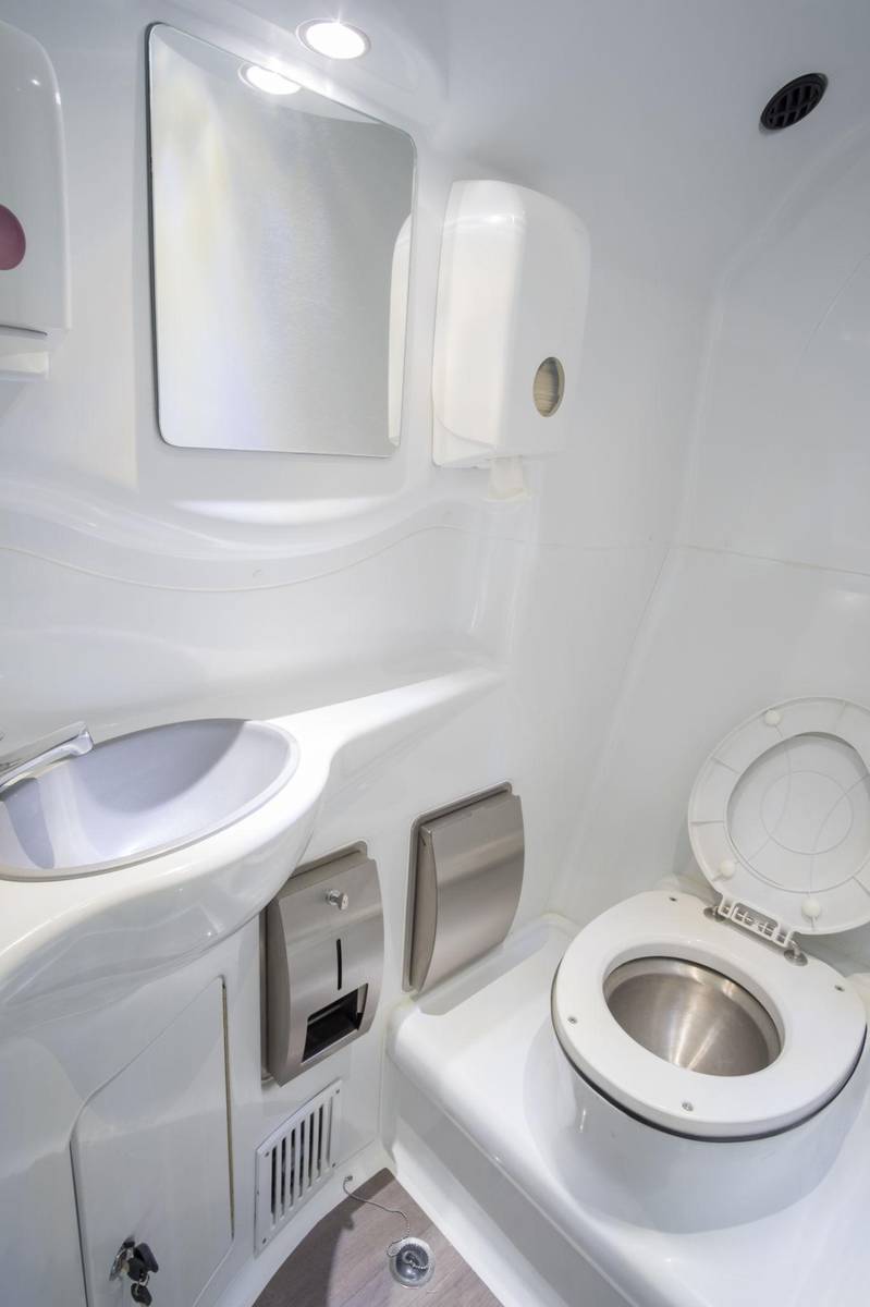 GenX bus toilet installed in luxury coach interior with wash basin and mirror