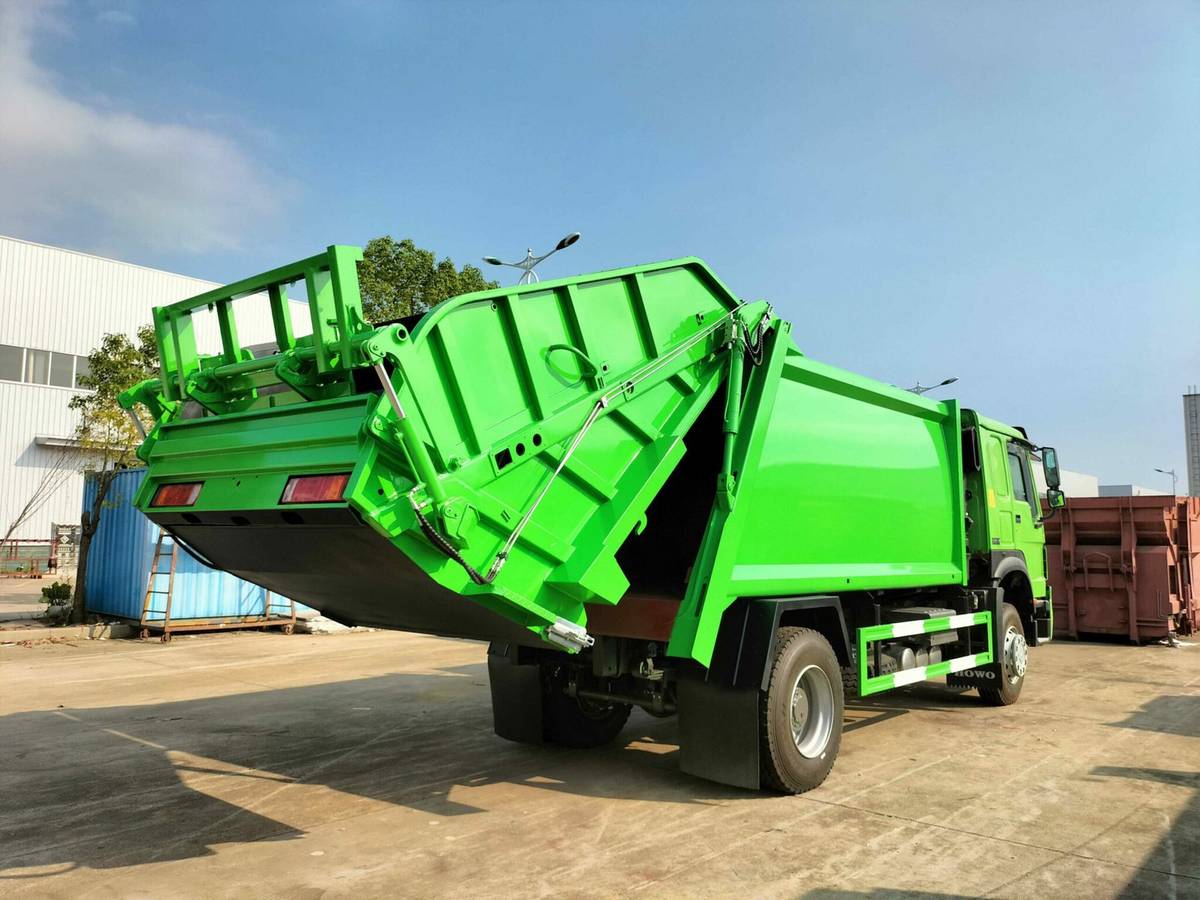 GenX garbage compactor truck rear loading view with hydraulic bin lifter
